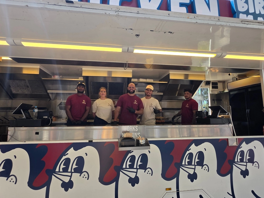The Birdman crew smiling at the serving hatch during the Samsung team lunch